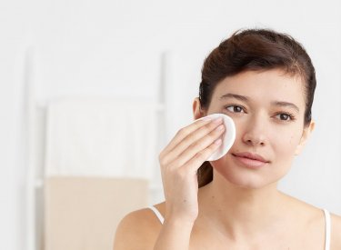 Bioderma - woman cleansing her face